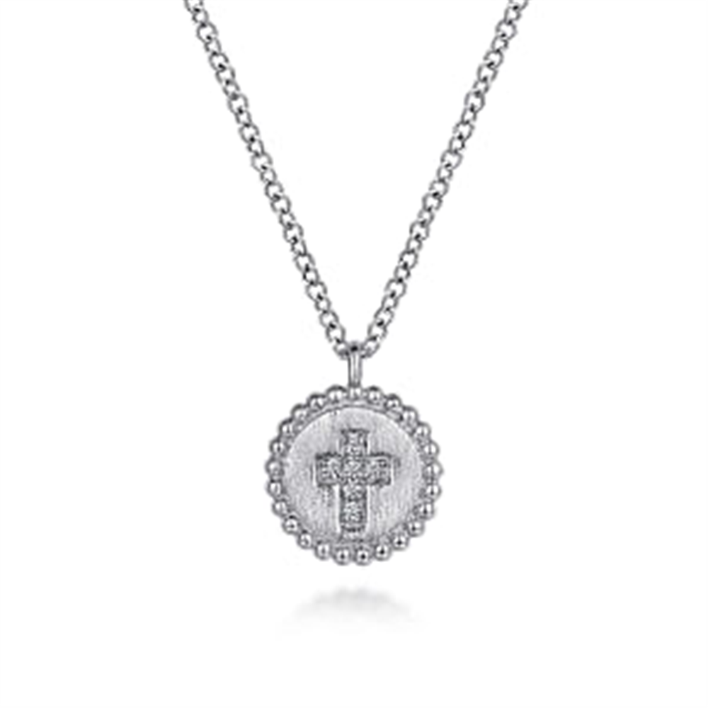 Introducing the Gabriel & Co 925 Sterling Silver Bujukan Diamond Cross Pendant Necklace. This exquisite piece from the Bujukan Collection features a round pendant with a beaded edge design, adorned with an engraved diamond cross at its center and small sparkling stones. The necklace includes a simple yet elegant silver link chain, all beautifully showcased against a white background.