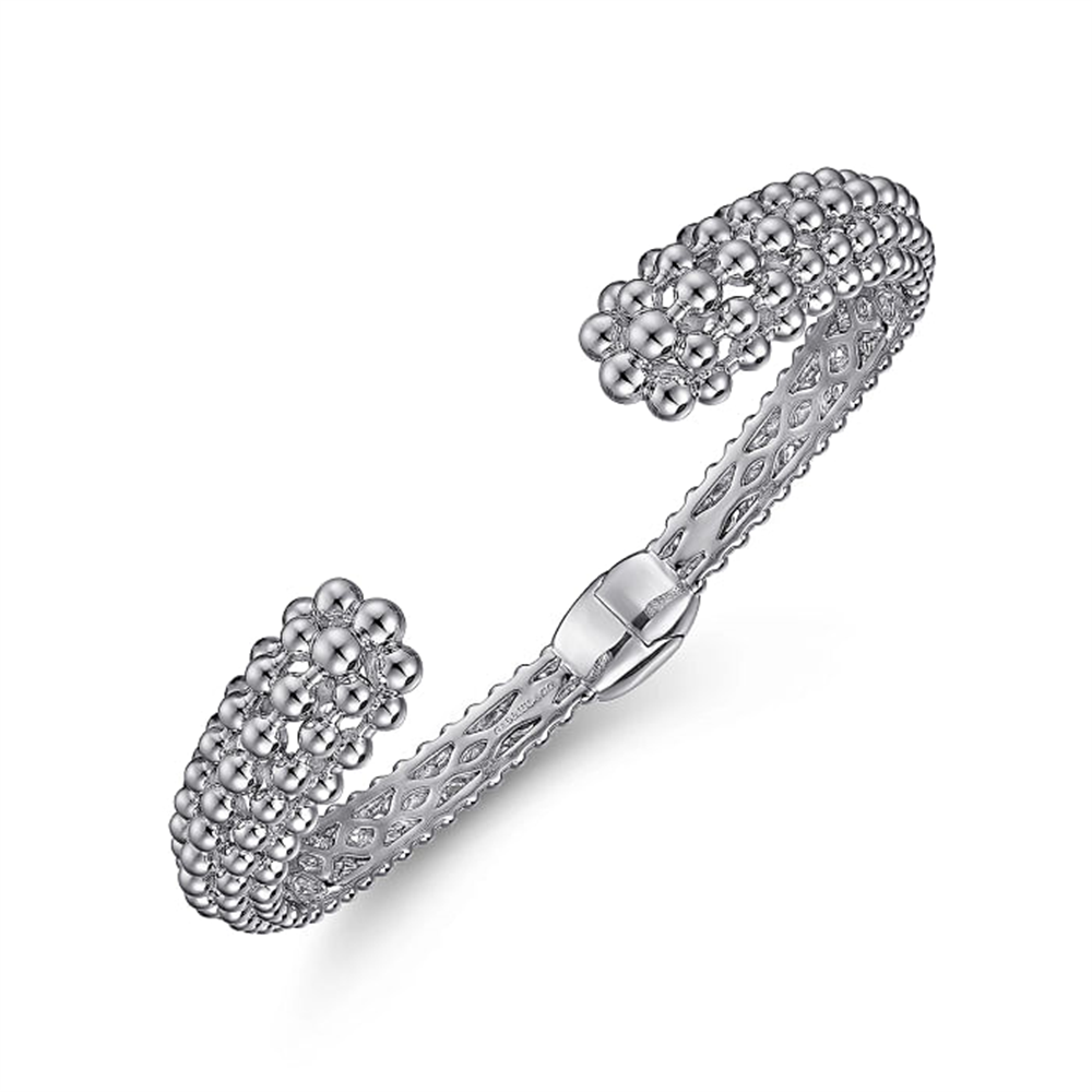 Introducing the Gabriel & Co 925 Sterling Silver Bujukan Hinged Cuff from the prestigious Bujukan Collection. This exquisite bracelet showcases an intricate, textured design with clusters of small silver beads adorning the open ends and a delicate lattice pattern along the band. Its hinge feature ensures easy adjustment to fit a variety of wrist sizes.