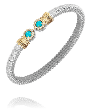 The Alwand Vahan Jewelry 4MM Turquoise bracelet showcases a silver band adorned with two gold accents. Each accent includes a 4MM turquoise stone surrounded by small white crystals, resulting in an elegant and stylish design.