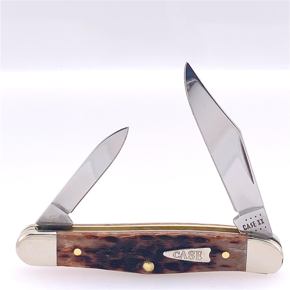 Introducing the Brown Bone Peach Seed Jig Half Knife by W.R. Case & Sons Cutlery Co. (Case 42654), featuring two open blades, a textured brown bone handle, and silver bolsters. The larger blade's base and a silver plaque on the handle are elegantly engraved with "CASE XX," making this Half Whittler a classic addition to any collection.