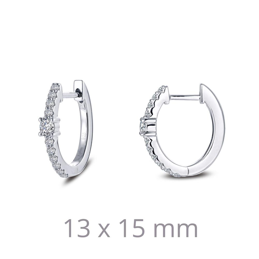 Lafonn's 13 mm x 15 mm Oval Huggie Hoop Earrings feature a pair of small hoops, each adorned with tiny, sparkling stones along one half. Displayed on a white background, these elegant earrings showcase their precise dimensions in subtle grey text below them.