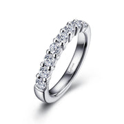 A sleek sterling silver ring adorned with a row of round-cut diamonds, set in a simple and elegant half-eternity band design by Lafonn. The inner band is engraved with the word "Leform.