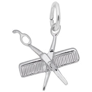 Introducing the Petite Comb & Scissors Charm in Sterling Silver by Rembrandt Charms. This graceful accessory showcases crossed scissors and a comb, equipped with a convenient loop for seamless attachment to your favorite bracelet or necklace.