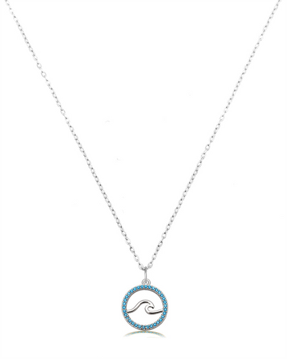 The Serenity Wave Sterling Silver Charm Necklace by T Jazelle features a round pendant with the Serenity Wave design, outlined in silver and bordered by blue stones, displayed on a delicate chain against a white background.