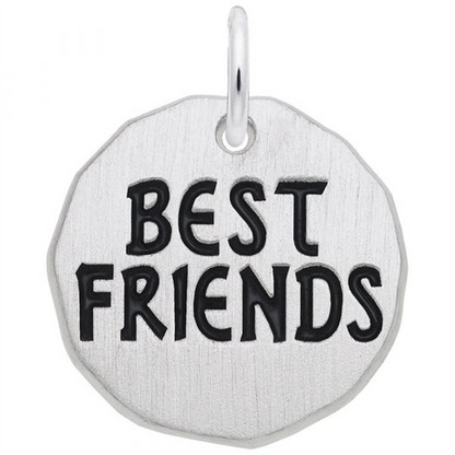 The Rembrandt Charms Best Friends Tag Charm is crafted from sterling silver in a round shape, featuring engraved black letters that spell "BEST FRIENDS." Designed with a small loop at the top, this charm is ideal for adding to a necklace or keychain, making it a meaningful piece of friendship jewelry.