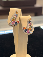 The Ryan Gems Multi Colored Sapphire Ear Climbers feature blue, orange, pink, and green sapphires set in 14k white gold, displayed on a beige jewelry stand.