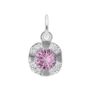 The Petite Birthstone - Feb Charm by Rembrandt Charms is a sterling silver pendant featuring a central sparkling pink birthstone, surrounded by an intricately textured silver design and a round loop at the top, giving it a delicate and elegant appearance.