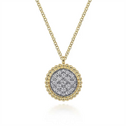 A close-up image of Gabriel & Co's 14K Yellow Gold Bujukan and Diamond Pavé Pendant Necklace. The pendant showcases a central section adorned with numerous small, sparkling diamonds, encircled by an intricate beaded gold border. The simple chain perfectly complements the elegant pendant.