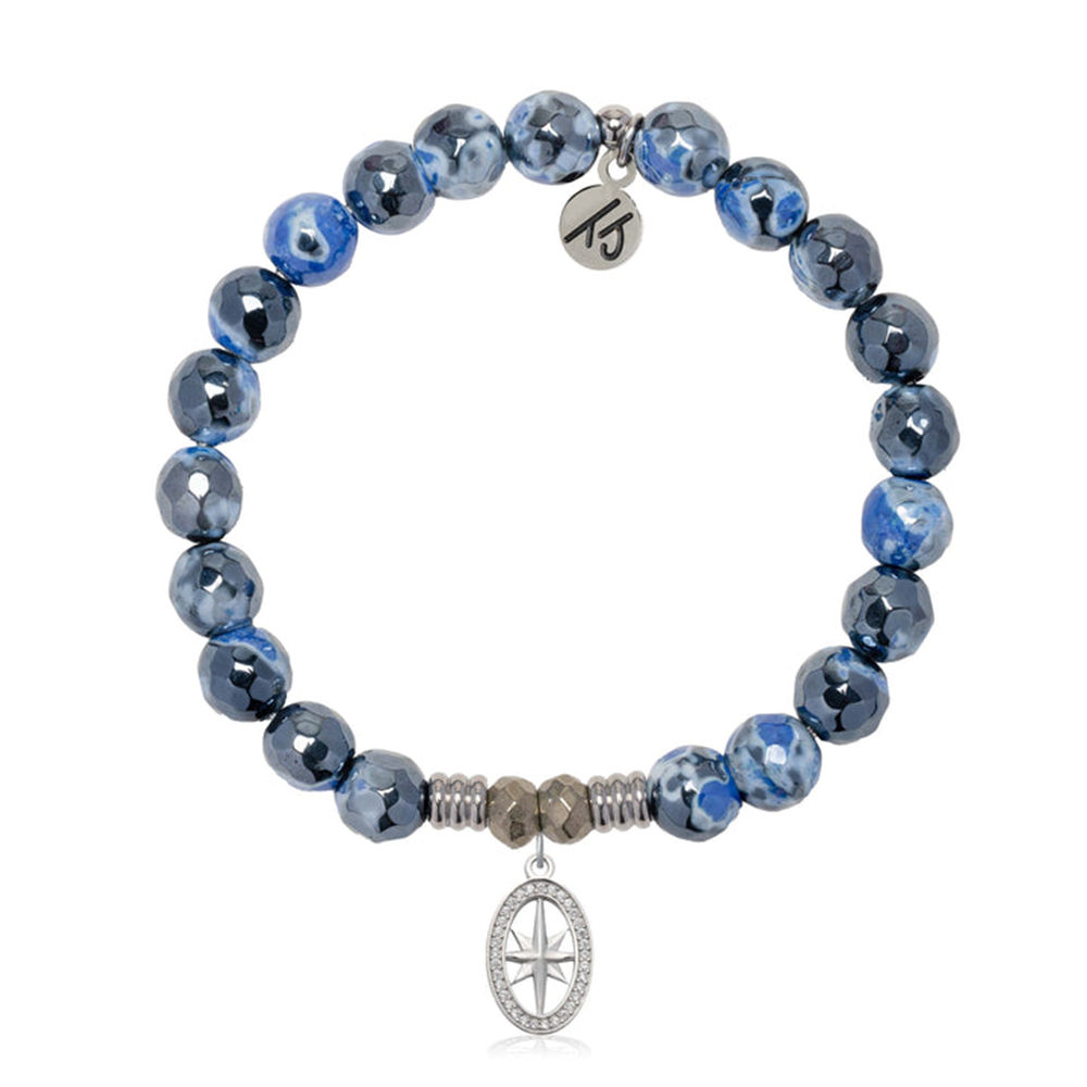 T Jazelle's Denim Blue Agate Gemstone Bracelet features marbled blue agate beads, silver spacers, a sterling silver compass charm, and a disc engraved with "15.