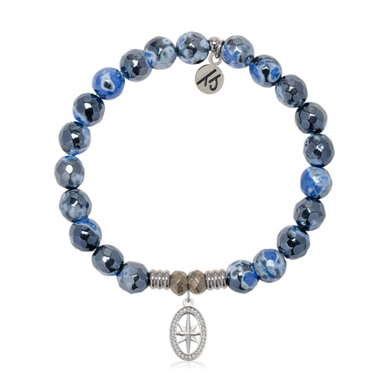 T Jazelle's Denim Blue Agate Gemstone Bracelet features marbled blue agate beads, silver spacers, a sterling silver compass charm, and a disc engraved with "15.
