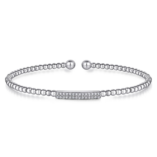 The 14K White Gold Bujukan Bead Bangle with Diamonds by Gabriel & Co is a delicate silver bracelet featuring small, round beads strung together with a central rectangular bar encrusted with sparkling crystals. Its adjustable ball ends ensure a comfortable fit, making this piece both elegant and versatile.