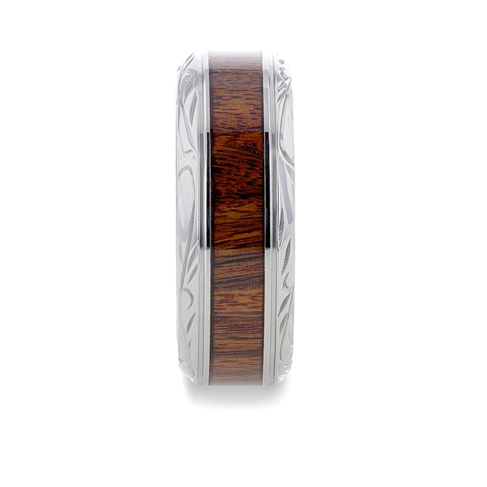 The Thorsten T1275-BWIP wedding ring features a polished titanium finish, intricate beveled edges, and a central inlay of black walnut wood, blending metal and wood elements seamlessly. The background is plain white.
