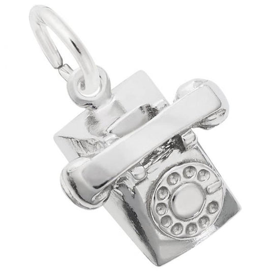 A Rotary Phone Charm / Sterling Silver by Rembrandt Charms. The charm features a detailed dial with circular holes and a handset resting on top. It has a loop at the top for attaching to a bracelet or necklace.