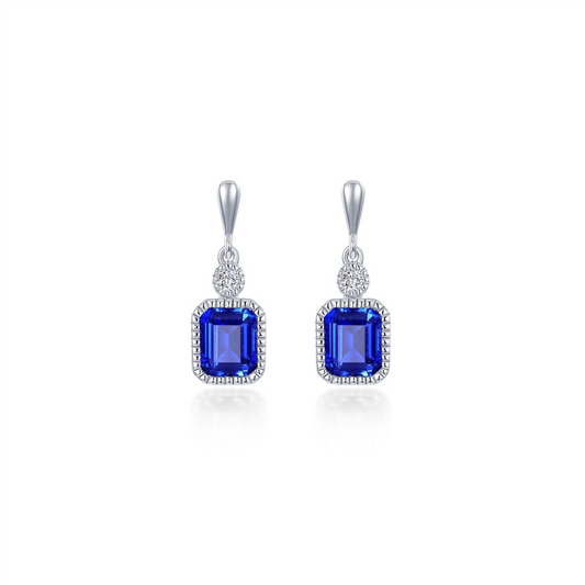 The Lafonn SEPT sim diamond, sapphire earrings feature rectangular blue gemstones framed by sparkling sim diamonds and a single round clear stone, all set in silver and elegantly suspended from a hook.