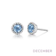 A pair of silver stud earrings featuring blue gemstones surrounded by small clear crystals from Lafonn, with the text "DECEMBER" written in purple at the bottom right corner, indicating these elegant December Birthstone Earrings.