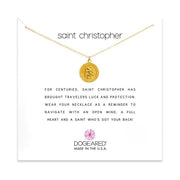 The Dogeared Saint Christopher /GP-SS / 18-inch gold circle pendant necklace is displayed against a white background. The card behind reads, "Saint Christopher" and describes the saint's protection for travelers. Below, "DogEared Made in the U.S.A." is printed.