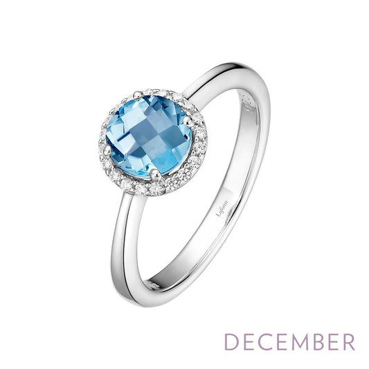 The December Birthstone Ring by Lafonn is a stunning silver piece, showcasing a large, round blue gemstone at its center, encircled by small diamonds. The phrase "December Birthstone" is elegantly written in light purple text at the bottom right corner.