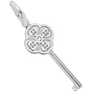 Introducing the "Key to My Heart March Stone Charm" by Rembrandt Charms: This sterling silver key pendant showcases a clover-like design with four-leaf motifs, each accented with a small March birthstone at the center. A heart shape embellishes the middle, and the key features a polished finish. It is attached to a round loop, perfect for wearing on a chain.