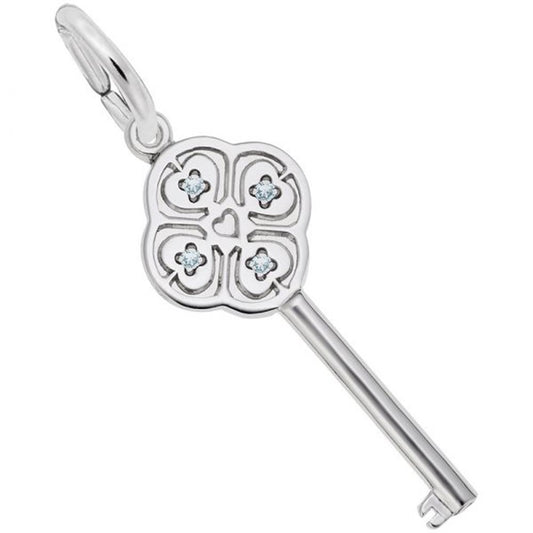 Introducing the "Key to My Heart March Stone Charm" by Rembrandt Charms: This sterling silver key pendant showcases a clover-like design with four-leaf motifs, each accented with a small March birthstone at the center. A heart shape embellishes the middle, and the key features a polished finish. It is attached to a round loop, perfect for wearing on a chain.