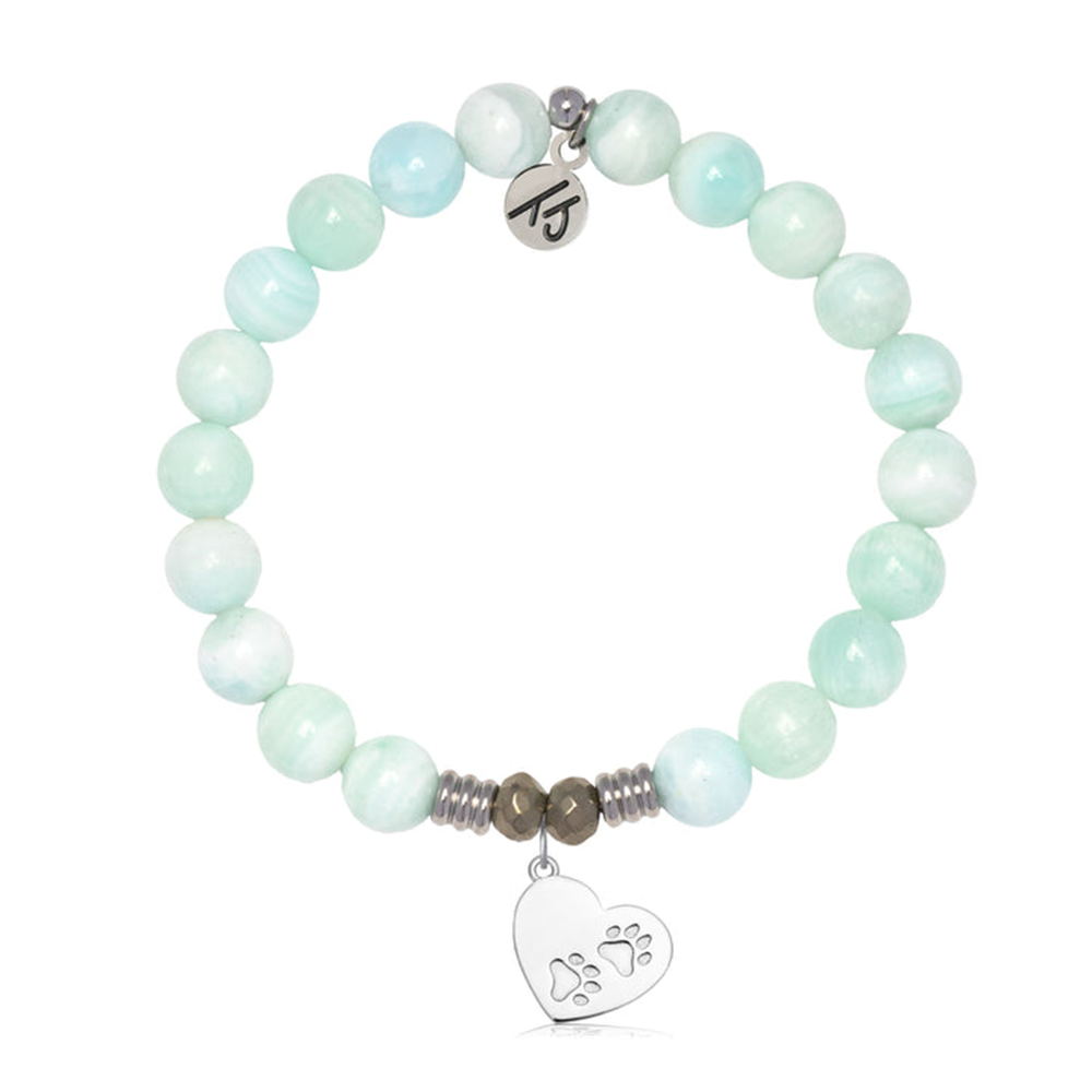 The T Jazelle Hemimorphite Gemstone Bracelet with Paws of Love Sterling Silver Charm features light blue and white beads, a sterling silver heart with paw prints, an engraved tag, and metallic spacers.