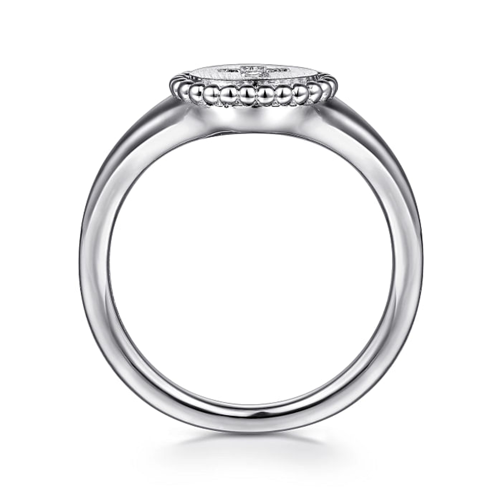 A close-up view of the Gabriel & Co Sterling Silver Signet Ring with Diamond Cross *Bujukan Collection*, featuring a smooth band and a round, intricately detailed bezel setting with a central diamond. The bezel is adorned with a delicate beaded edge, enhancing the elegance of the ring. The background is plain white.