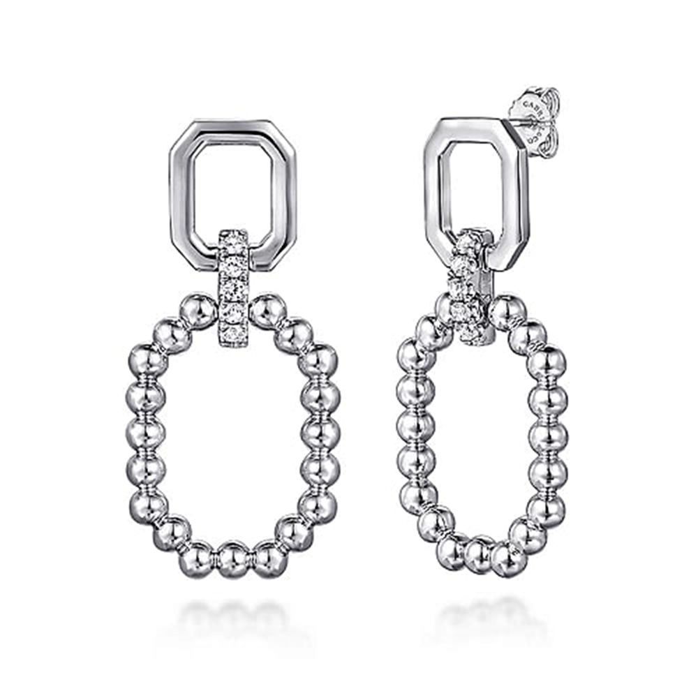 Introducing the Gabriel & Co. 925 Sterling Silver Octagon White Sapphire Bujukan Stud Drop Earrings, a pair of modern dangling earrings with a captivating geometric design. Each earring features a sterling silver octagonal top linked to an oval hoop adorned with small silver beads. A row of clear white sapphires elegantly connects the octagon to the bead hoop, all crafted in shiny silver from the stunning Bujukan Collection.