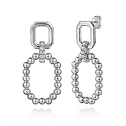 Introducing the Gabriel & Co. 925 Sterling Silver Octagon White Sapphire Bujukan Stud Drop Earrings, a pair of modern dangling earrings with a captivating geometric design. Each earring features a sterling silver octagonal top linked to an oval hoop adorned with small silver beads. A row of clear white sapphires elegantly connects the octagon to the bead hoop, all crafted in shiny silver from the stunning Bujukan Collection.