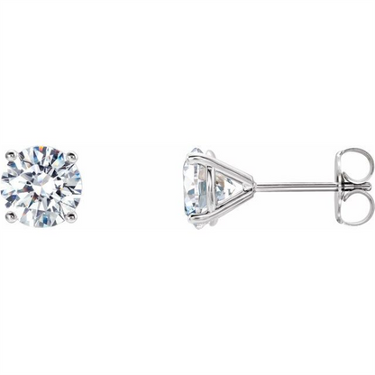 Simply Diamonds' 14KW 1/2 CTTW Lab Grown Diamond Studs feature round-cut lab grown diamonds set in prong settings. The earrings boast a simple, elegant design with prominently displayed diamonds. One earring is shown from the front, while the other is shown from the side to highlight the setting and post.