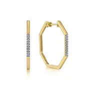 Explore the stunning Gabriel Earrings by Gabriel & Co: gold hexagonal hoops featuring a line of embedded diamonds on one side, delivering an elegant sparkle from every angle.