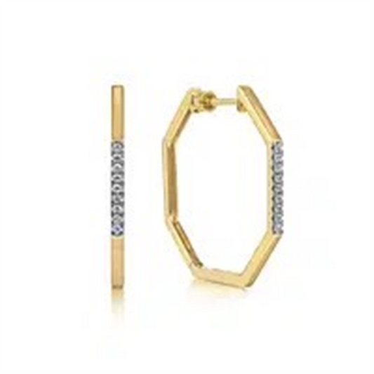Explore the stunning Gabriel Earrings by Gabriel & Co: gold hexagonal hoops featuring a line of embedded diamonds on one side, delivering an elegant sparkle from every angle.