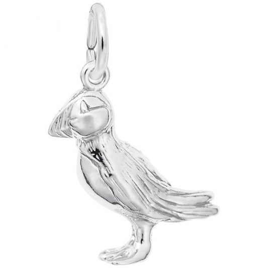 A detailed image of the Sterling Silver Puffin Charm by Rembrandt Charms. This charm features an intricately detailed puffin, measuring 0.24 inches by 0.68 inches (6.2 mm by 17.33 mm). The charm has a polished sterling silver finish, perfect for adding a touch of whimsical wildlife to any charm bracelet or necklace. Style number 3384.