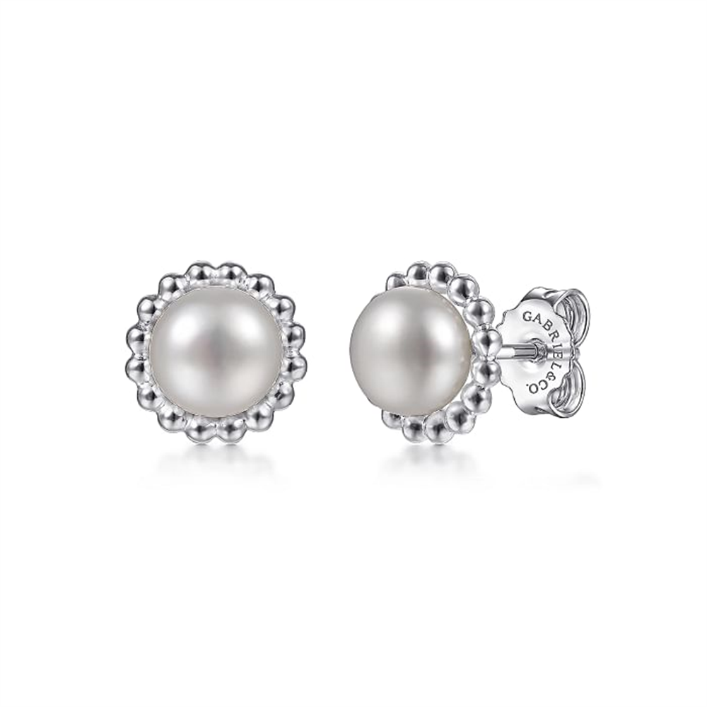Introducing the 925 Sterling Silver Bujukan Pearl Stud Earrings from Gabriel & Co's *Bujukan Collection*. These elegant earrings feature centrally placed pearls, adorned with a detailed silver beaded border. Crafted from 925 sterling silver, they are held securely by backs inscribed with the manufacturer's name. This classic and sophisticated design is perfect for various occasions.
