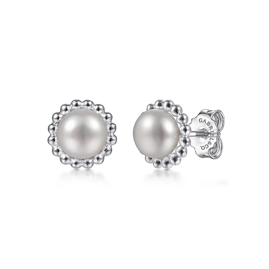Introducing the 925 Sterling Silver Bujukan Pearl Stud Earrings from Gabriel & Co's *Bujukan Collection*. These elegant earrings feature centrally placed pearls, adorned with a detailed silver beaded border. Crafted from 925 sterling silver, they are held securely by backs inscribed with the manufacturer's name. This classic and sophisticated design is perfect for various occasions.