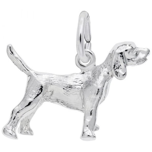 The Beagle Dog Charm in sterling silver by Rembrandt Charms features a detailed beagle with its tail raised and head turned slightly to the side. The charm showcases intricate details such as ears, eyes, and fur texture, and includes a small loop at the top for easy attachment to a bracelet or necklace.
