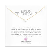 A gold chain necklace, 18" long, featuring a single pearl pendant is showcased against a white background. The card behind the necklace reads "Pearls of Friendship" and includes a sentiment about the beauty of both friendship and pearls. This elegant piece is from the brand Dogeared, made in the USA.