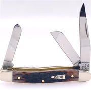 A Case 42651 Medium Knife by W.R. Case & Sons Cutlery Co., featuring three open blades, a Brown Bone Peach Seed Jig handle with a worn, rugged texture, brass lining, and a metal emblem labeled "CASE." The shiny metallic larger blade is marked "CASE XX.