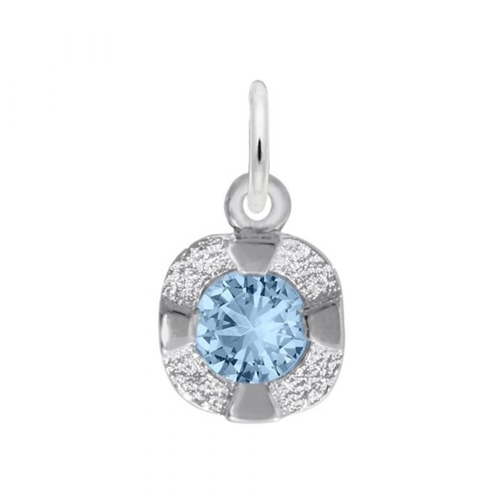 A close-up image of the Petite Birthstone - December Charm by Rembrandt Charms, crafted in sterling silver. This pendant features a round, blue birthstone at its center, surrounded by a textured silver design set in a slight cushion shape. It includes a loop at the top for easy attachment to a chain or necklace, making it an ideal gift for someone with a December birthday.