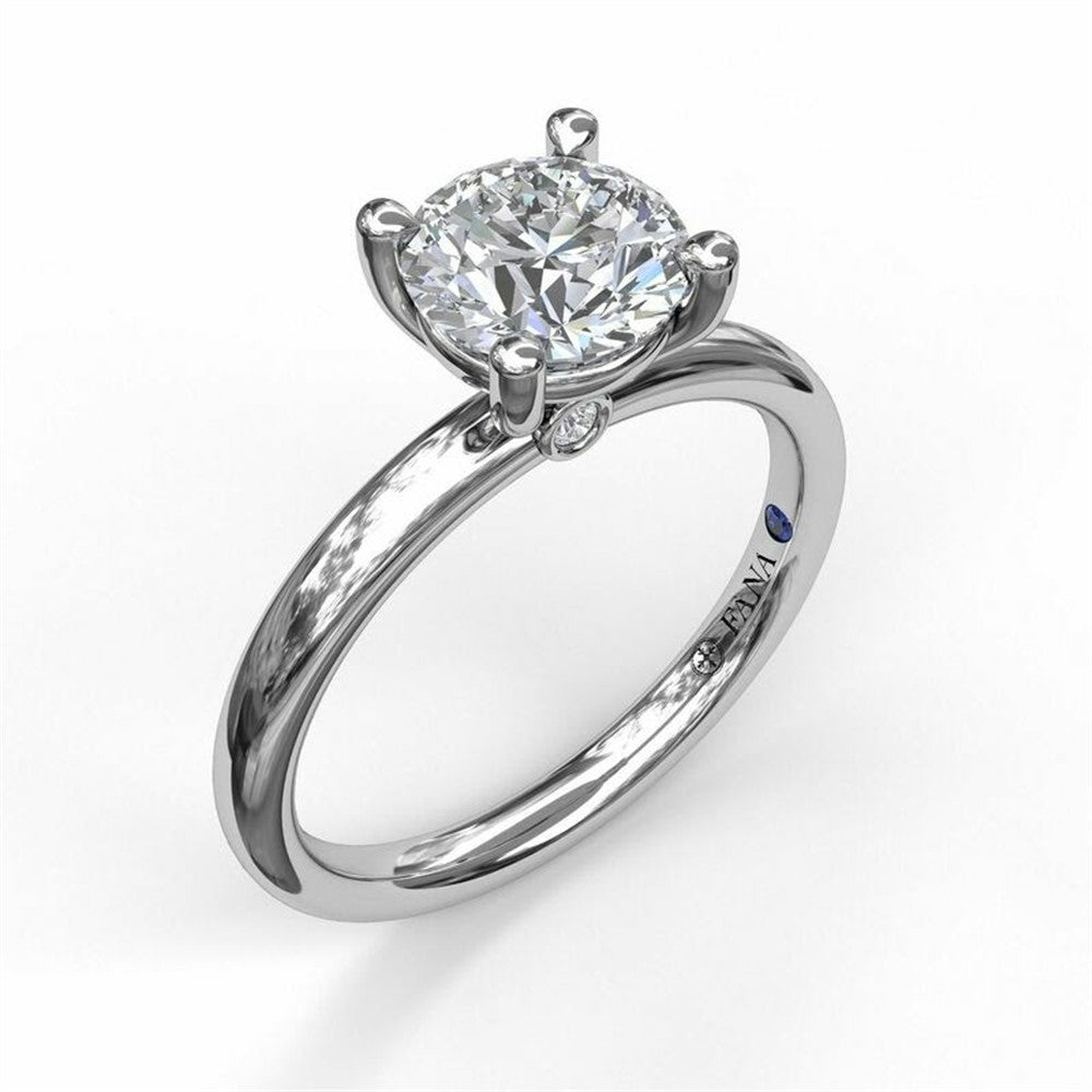 The FANA 14K White Gold Classic Round Cut Solitaire Engagement Ring features a large, conflict-free round diamond in a four-prong setting, slender polished band, and a blue gemstone hidden inside.