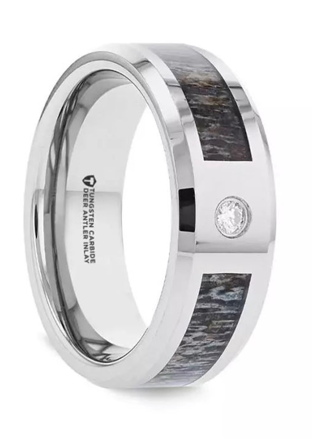 The COLTON Tungsten Carbide Ring by Thorsten showcases a polished silver band with a dark wood and deer antler inlay, accented by a small, round diamond set into the surface. The inside of the 8mm band features engraved text detailing the ring's material.
