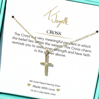 The T Jazelle Cross CZ Gold Charm Necklace features a 14k gold plated sterling silver cross with a CZ gemstone on an adjustable chain, displayed on a card with a motivational faith and strength message.
