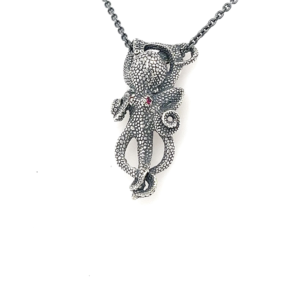 The Kabana SS Octopus Pendant w Ruby Eyes - OXIDZD - 18IN features textured sterling silver with curled tentacles and ruby eyes, displayed on an 18-inch chain against a white background.