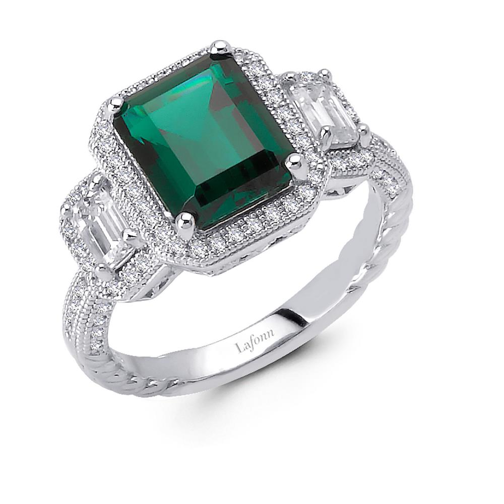 The Three-Stone Anniversary Ring by Lafonn is a sterling silver ring showcasing a large, rectangular green gemstone at its center, with two smaller rectangular clear stones on each side. The intricately detailed band is encrusted with small simulated diamonds, and the word "Lafonn" is engraved inside the band.