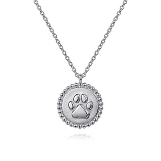 This exquisite 925 Sterling Silver Bujukan Paw Print Pendant Necklace from Gabriel & Co features a round pendant with a beaded edge, showcasing an embossed paw print at its center.