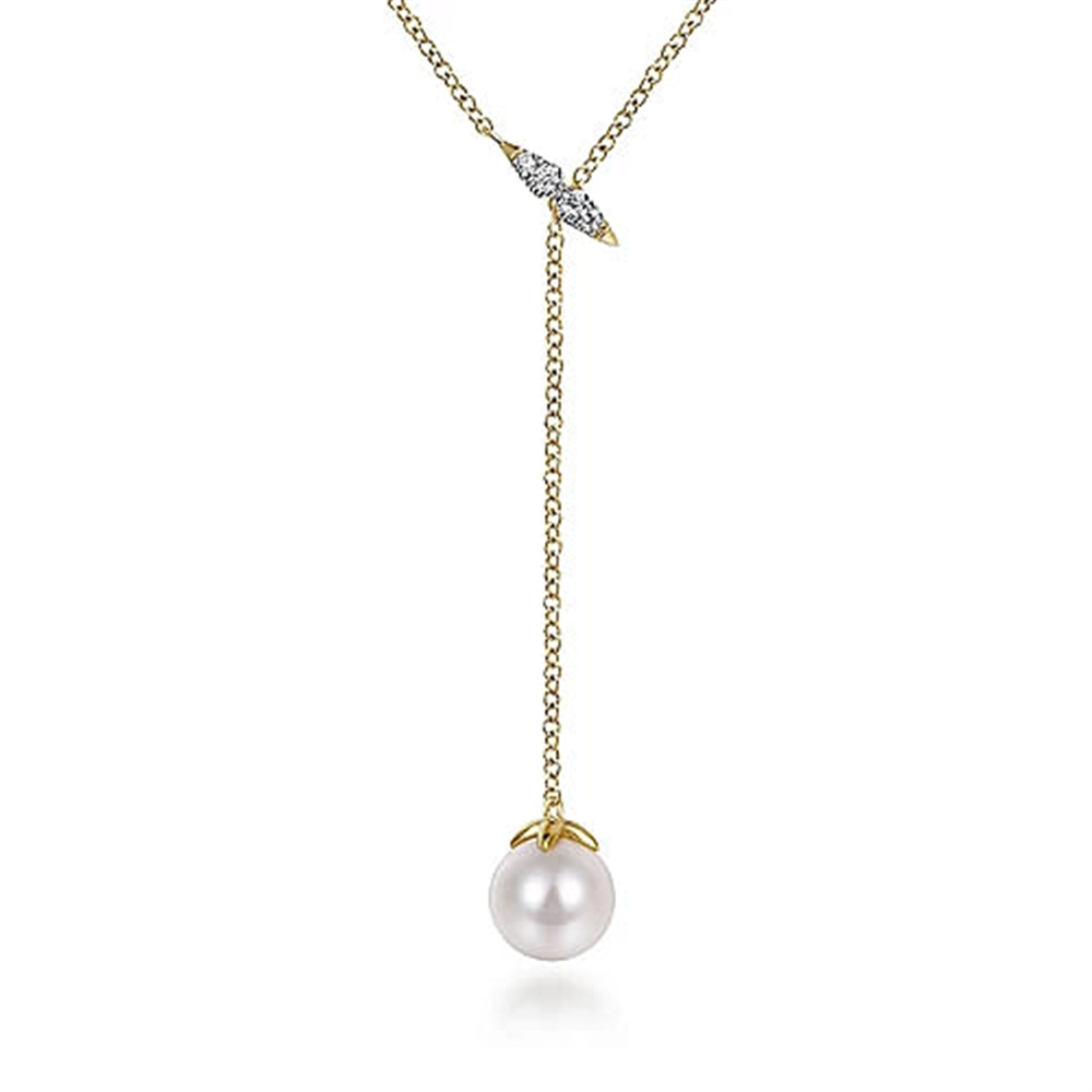 The 14K Yellow Gold Diamond And Pearl Y Knot Necklace by Gabriel & Co features a delicate design with a single white pearl pendant at the end. The chain is adorned with a small diamond-studded leaf near the clasp, creating an elegant and minimalist look.