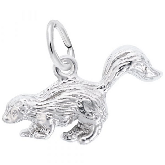 The Skunk Charm in Sterling Silver by Rembrandt Charms features a shiny finish and a raised, bushy tail. This piece showcases detailed fur textures and includes a small loop for easy attachment to a chain or bracelet.