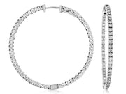 The 14k WG 41mm diamond hoops from Royal Jewelry showcase two silver hoops encrusted with small, sparkling stones that shimmer effortlessly. Crafted in 14k white gold, these earrings are displayed from both the front and side view to highlight their circular shape and intricate design.