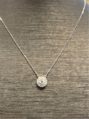 The Ryan Gems Diamond Circle Disc Pendant features a round diamond-encrusted pendant on a delicate 14k white gold chain, elegantly displayed on a gray textured bust.