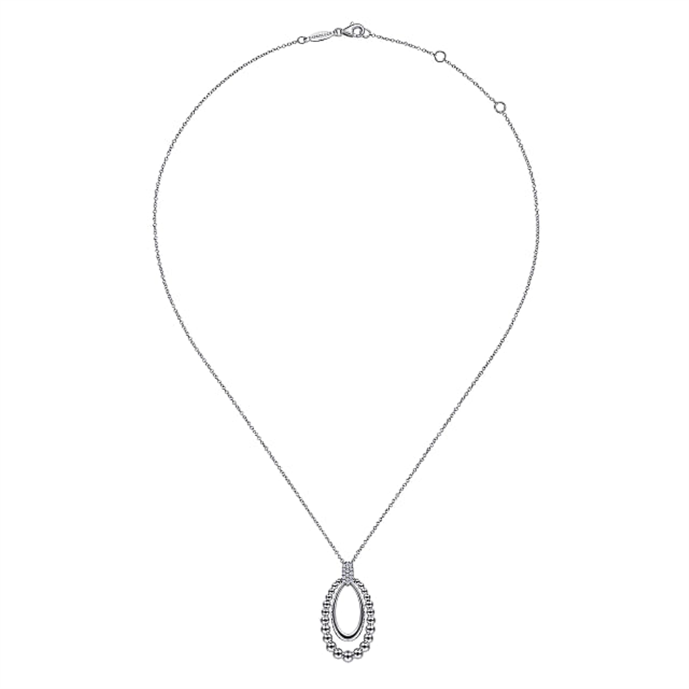 A delicate 925 Sterling Silver White Sapphire Pendant Necklace from Gabriel & Co's Bujukan Collection, featuring a fine chain and an open oval pendant. The outer edge of the pendant is adorned with small, sparkling white sapphires, creating an elegant, shimmering effect. Serial No: S17.