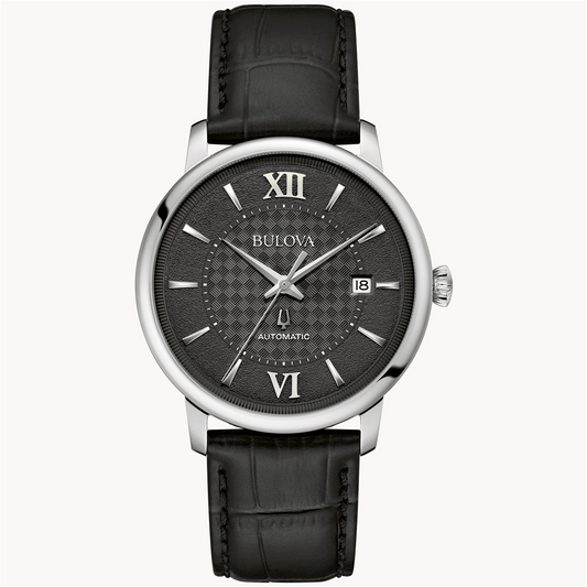 The Bulova Hudson Black Dial Leather Strap Watch by Bulova Watch Company features a black leather strap, silver case, sapphire crystal, black textured dial, silver markers, Roman numerals at 12 and 6, date at 3 o'clock, and "AUTOMATIC" above 6.