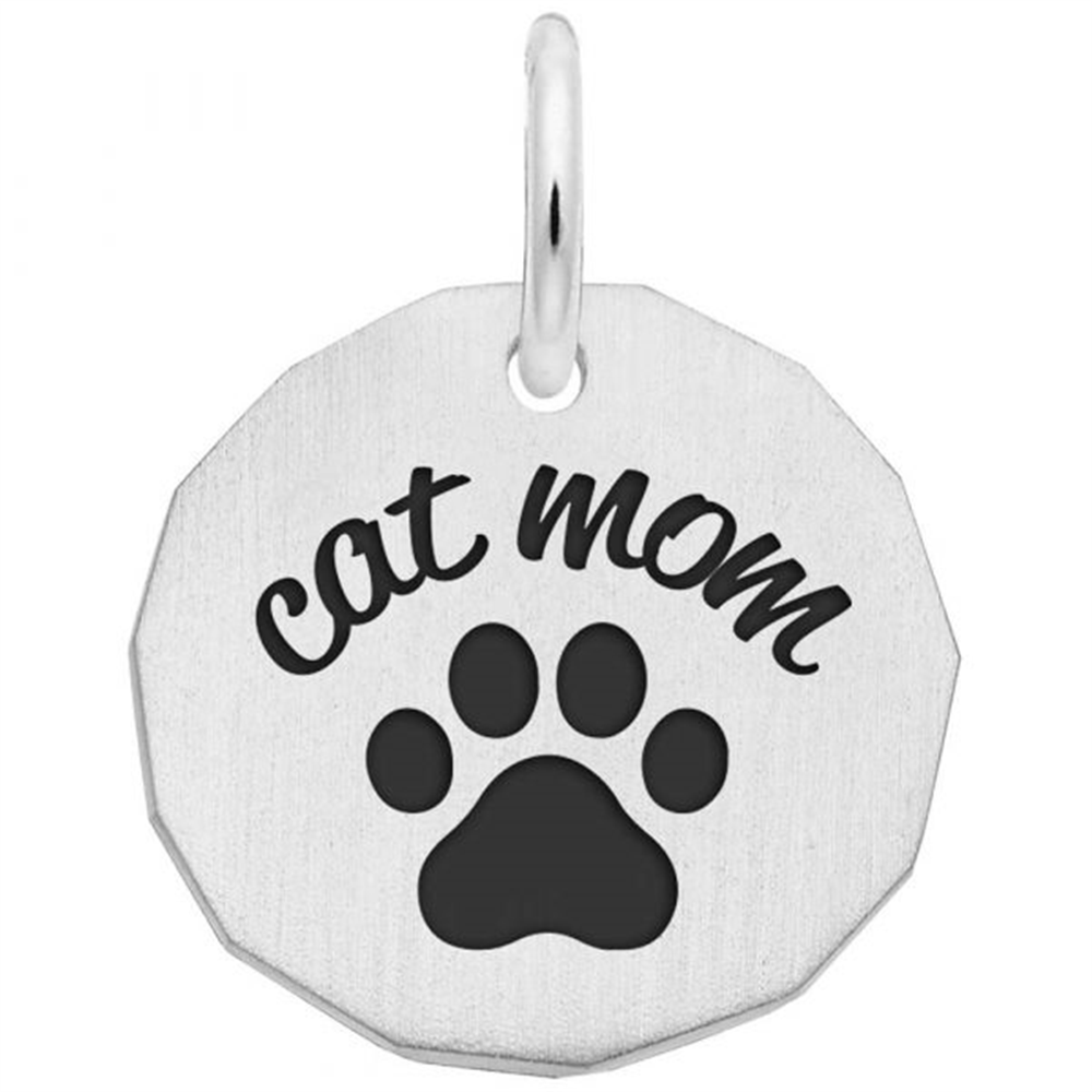 The Rembrandt Charms Cat Mom Charm is a sterling silver pendant featuring a black paw print with "cat mom" engraved above it, designed in a round shape with slightly faceted edges and a top loop for easy attachment to your favorite chain.
